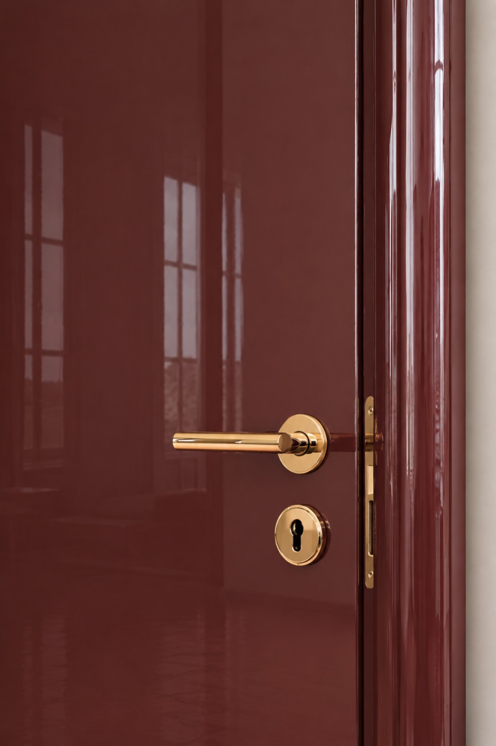 Close-up showing a deep burgundy piano-lacquer finish on a Doors Dublin MDF door and matching rounded frame